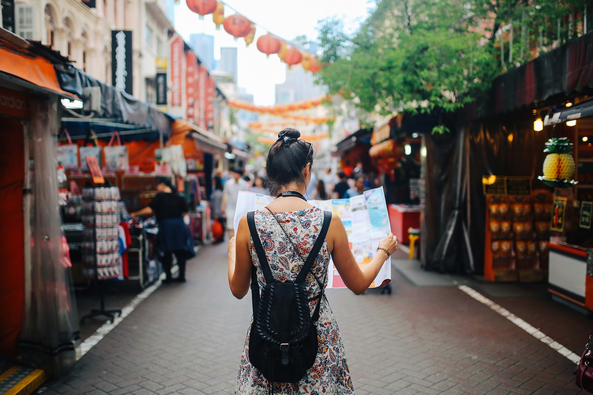 A girl holding a map in Singapore.